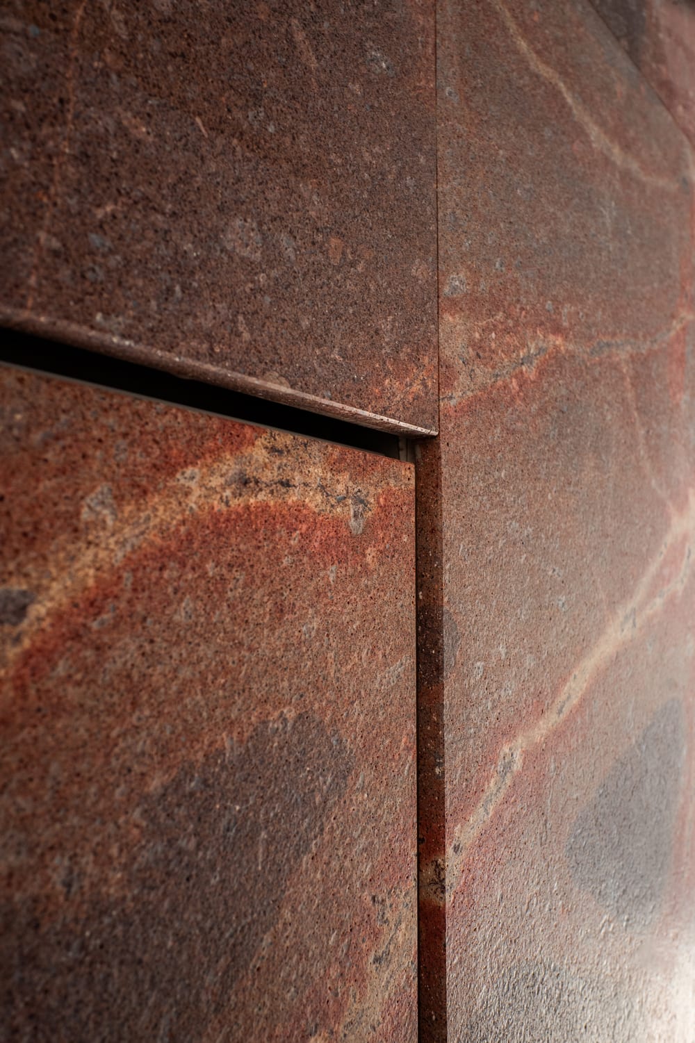 Red marble with a brass handle.